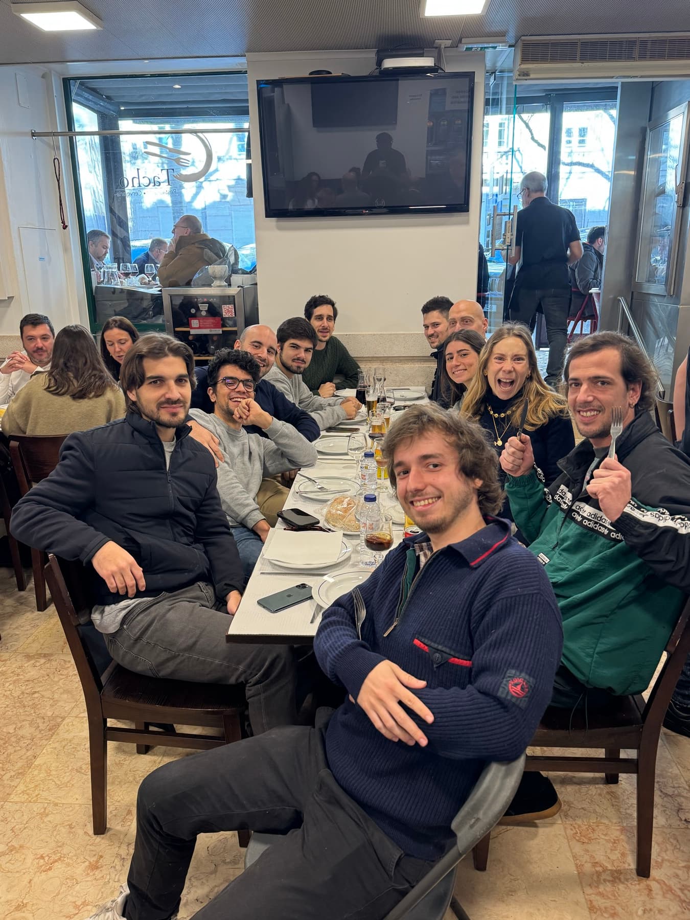 lunch at a long table, everyone talking at once
