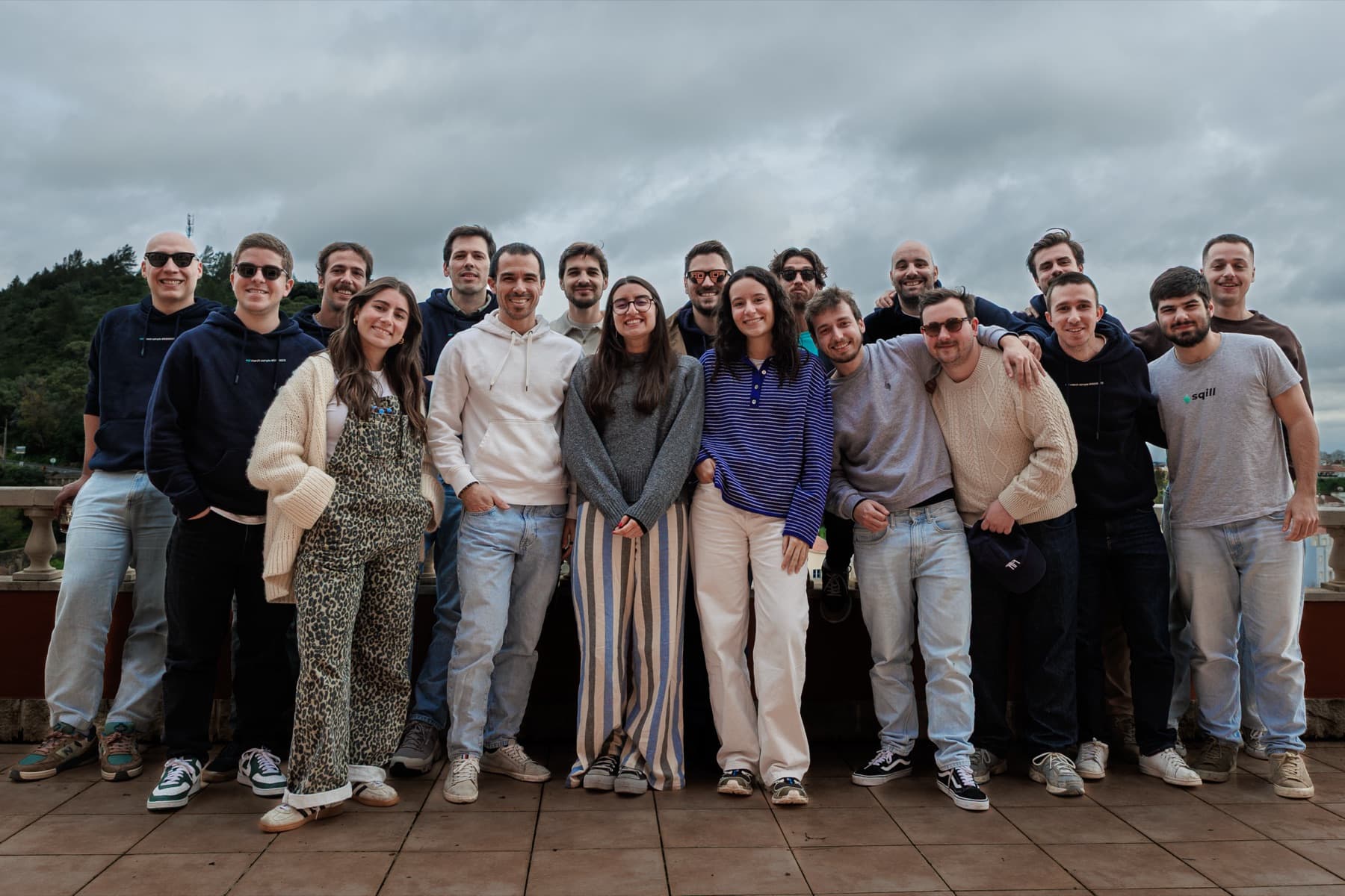 the whole team lined up on a rooftop terrace