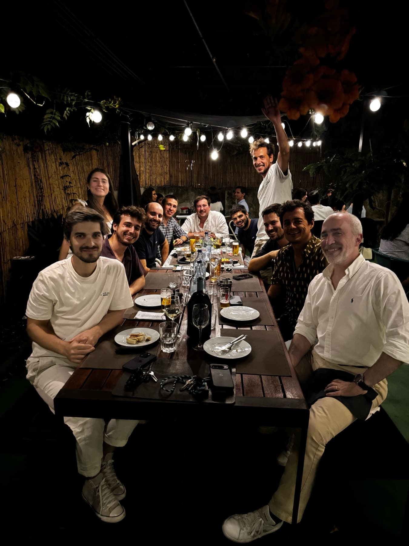 dinner under string lights, one of us standing on a chair
